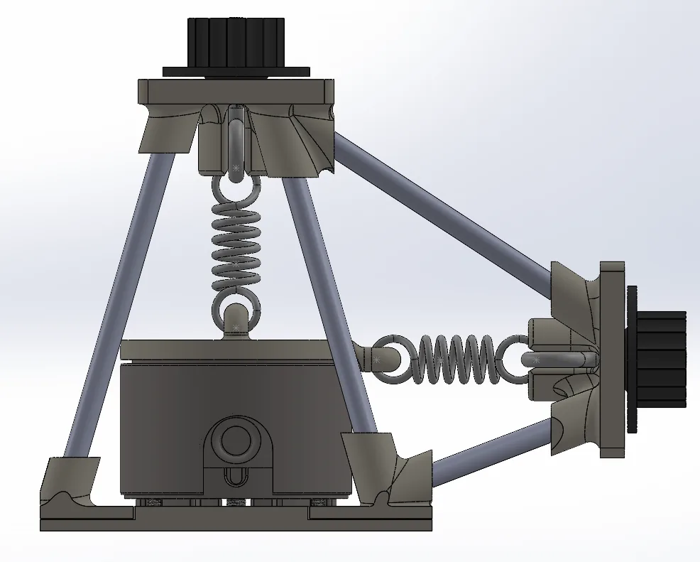Side view CAD render: a vertical spring from the top knob pulls up on the loading piece above the load cell, and a horizontal spring from the side knob pulls sideways; steel tubes brace both knob mounts to the base.