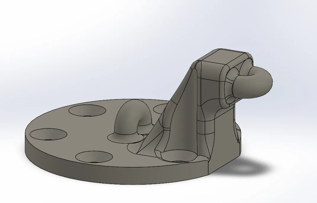 CAD render of the loading piece: a disc with six bolt holes, a low hoop on top for the axial spring and a raised filleted hoop on one side for the transverse spring.